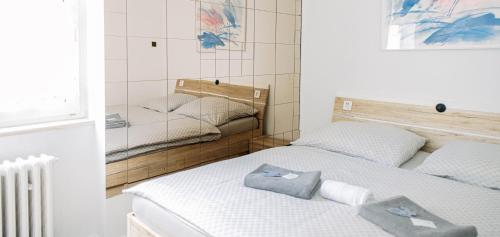a bedroom with two twin beds with towels on them at M-Tourist in Prague
