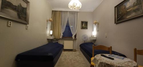 a room with a bed and a table and a window at Gasthaus Schmidt's in Neuhaldensleben