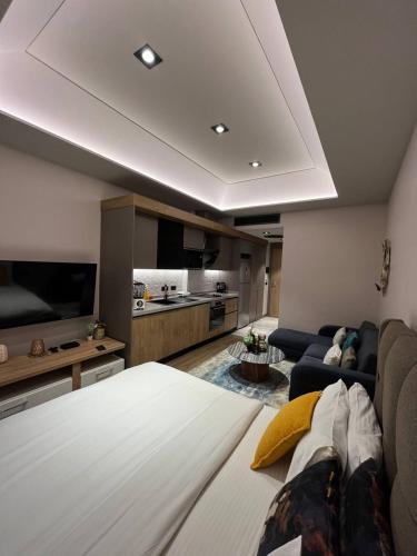 a living room with a bed and a couch at The Diamond In City Luxury Suites By ZENORA Living in Accra
