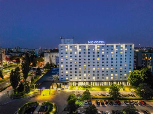 a large building with a sign on top of it at Novotel Kraków City West in Kraków