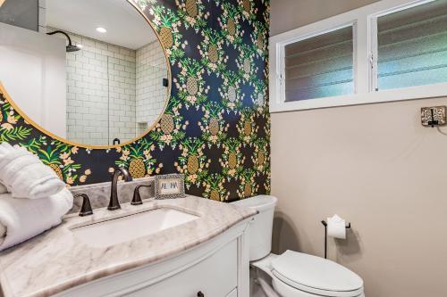 a bathroom with a sink and a mirror at 2BR 2BA The Aloha Cottage in Lahaina