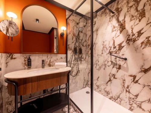 a bathroom with a sink and a shower at Mercure Gdynia Centrum in Gdynia