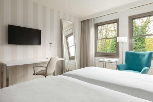 Una cama o camas en una habitación de NH Bussum Jan Tabak