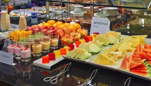 a buffet of fruit and vegetables on a table at NH Sants Barcelona in Barcelona