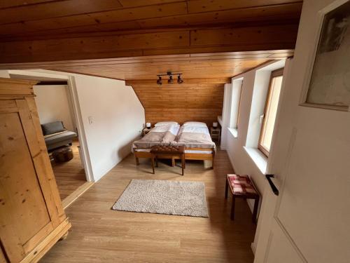 an attic room with a bed in a wooden house at Ferienwohnungen Zum Alten Buchbinder in Guntersblum
