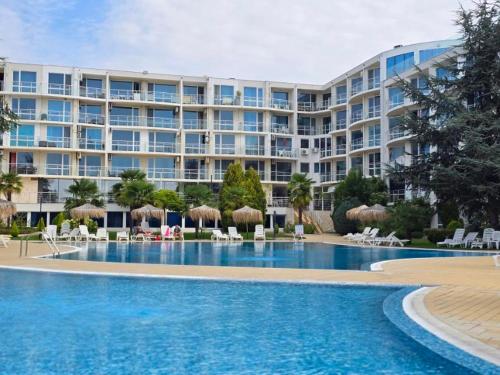 a large apartment building with a large swimming pool at Sarafovo ATLANTIS 58 in Burgas City