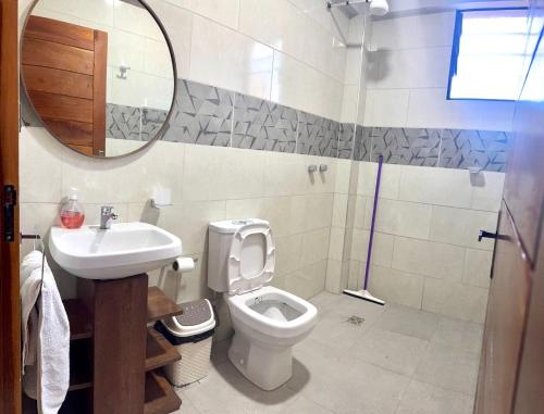 a bathroom with a toilet and a sink and a mirror at Alojamiento Bilbao in Quillacollo