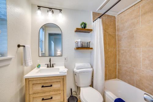 a bathroom with a sink and a toilet and a tub at 3 Mi to Downtown Dallas Sleek Condo with Patio in Highland Park