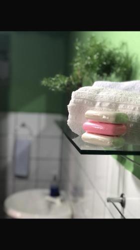 two towels and toothbrushes on a glass shelf in a bathroom at Restaurante e Pousada Mandacaru Abacate in Campestre