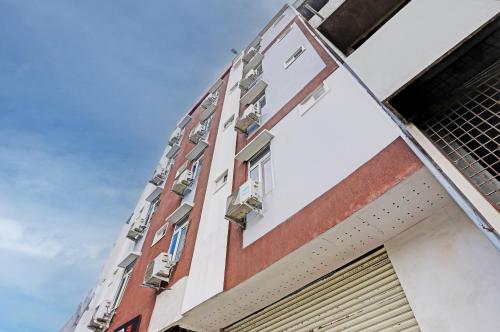 a building with windows and a blue sky in the background at Hotel O Shiridi Residency in Vidya Nagar