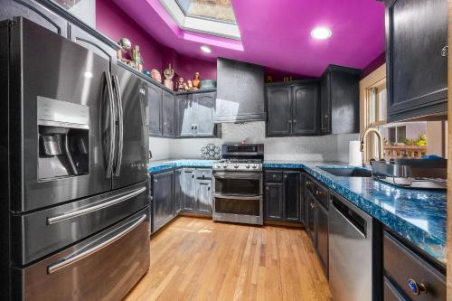 a kitchen with stainless steel appliances and purple ceilings at Charming 5 BD Victorian House by Beach Boardwalk in Santa Cruz