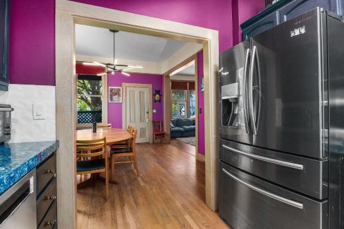 a kitchen with a stainless steel refrigerator and a table at Charming 5 BD Victorian House by Beach Boardwalk in Santa Cruz