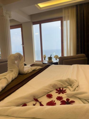 a hotel room with a bed with flowers on it at Al-Borg Al-Watheer Serviced apartments in Jazan