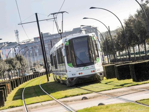 a white train is traveling down the tracks at ibis Nantes Saint Herblain in Saint-Herblain