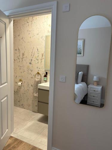 a bedroom with a mirror and a bed and a sink at Country Escape in Cloneen