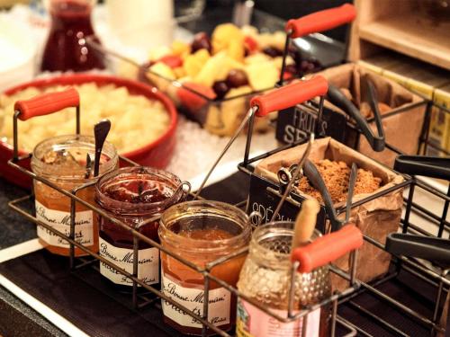 a bunch of food in containers on a counter at ibis Maisons Laffitte in Maisons-Laffitte