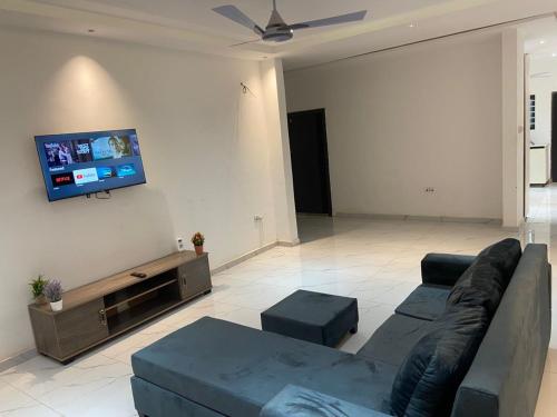 a living room with a couch and a flat screen tv at 2BR House in Gbawe in Gbawe
