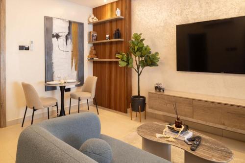a living room with a couch and a tv at Belfast studio-Blue Waters Property Management in Accra