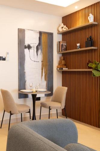a room with a table with chairs and a painting at Belfast studio-Blue Waters Property Management in Accra
