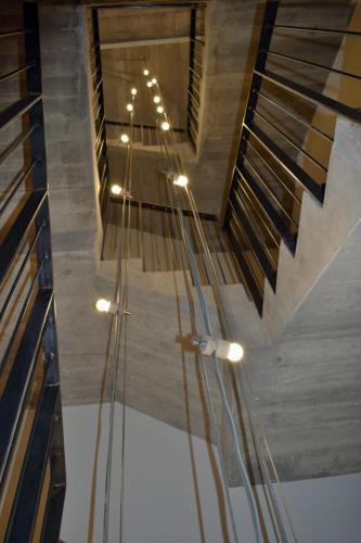 a vaulted ceiling with a staircase in a room at Hostal Boutique Restaurante El Algars in Caseras