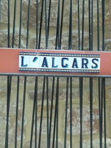 a sign that says ladders on a iron gate at Hostal Boutique Restaurante El Algars in Caseras