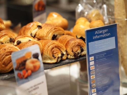a bunch of pastries on display in a bakery at Mercure Nantes Centre Gare in Nantes
