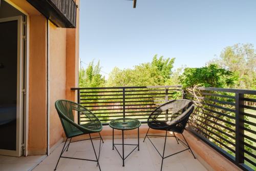 two chairs and a table on a balcony at Villa with Private Garden & Pool Ourika, Atlas Mountains in Sidi Bouzguia