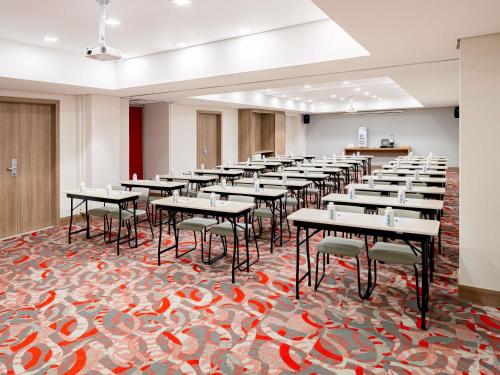 a row of tables and chairs in a room at Mercure Sao Paulo Moema Times Square in Sao Paulo