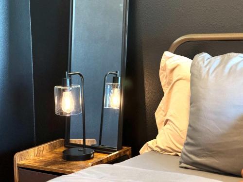 a bedroom with a bed and two lights on a night stand at Luxury Haven 10 Min From Disneyland With Pool & GYM in Tustin