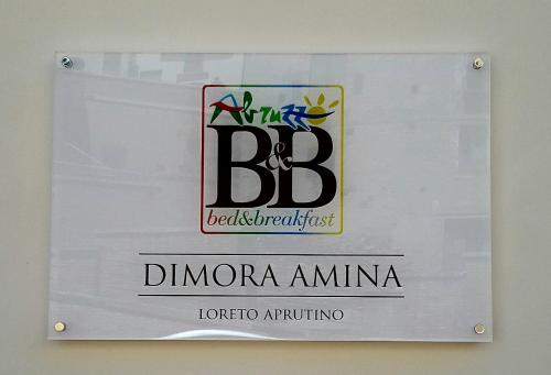 a sign on a wall with the bc logo at Dimora Amina in Loreto Aprutino