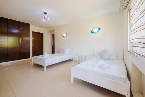 a white room with two beds and a window at Villa with Private Garden & Pool Ourika, Atlas Mountains in Sidi Bouzguia