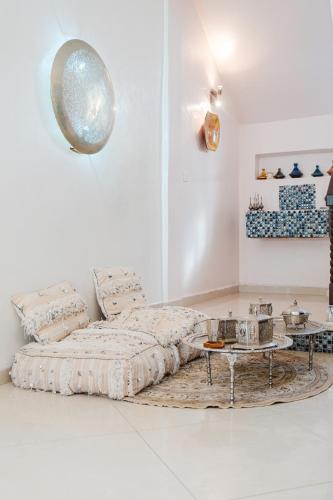 a white room with a bed and a table at Villa with Private Garden & Pool Ourika, Atlas Mountains in Sidi Bouzguia