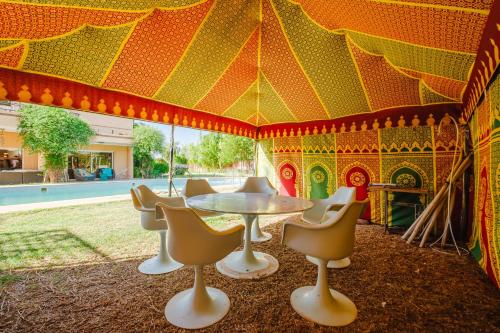 a tent with a table and chairs in it at Villa with Private Garden & Pool Ourika, Atlas Mountains in Sidi Bouzguia