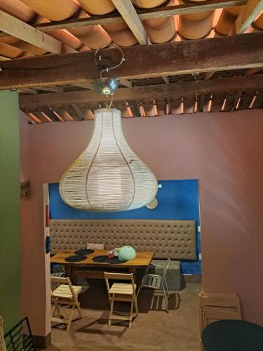 a light fixture hanging over a table in a room at Casa Cores da Redonda! in Icapuí