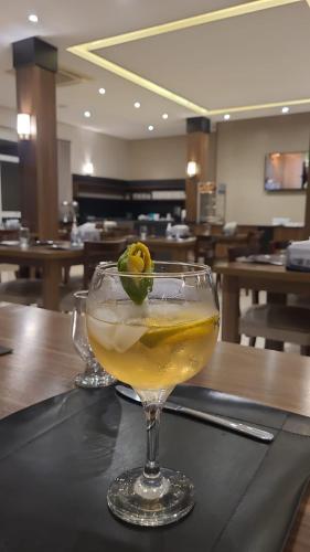 a drink in a glass sitting on a table at Executivos Hotel in Cruz Alta