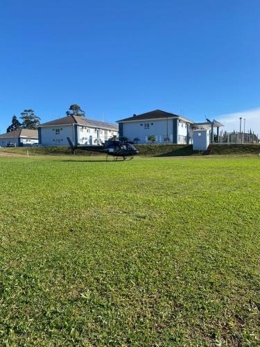 a plane is parked in a field of grass at Executivos Hotel in Cruz Alta