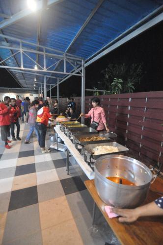 a group of people preparing food in a buffet at Banana Resort Sadao in Sadao