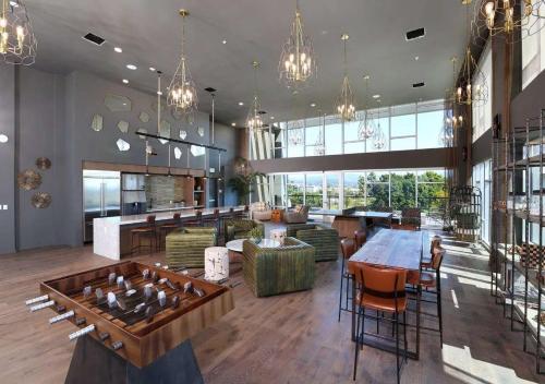 a large room with a table and chairs and a lobby at Upscale Escape 10 Min from Disneyland With Pool & Gym in Santa Ana