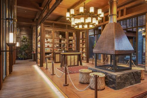 a large library with a fireplace and a chandelier at Plataran Puncak Suites in Puncak