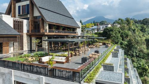an image of a building with a balcony with a restaurant at Plataran Puncak Suites in Puncak