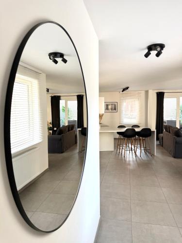 a mirror on a wall next to a living room at Appartement au coeur de Spa avec parking privé in Spa