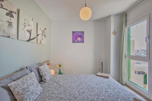 a bedroom with a bed and a large window at Duplex in Playa De Las Américas-center in Playa de las Americas