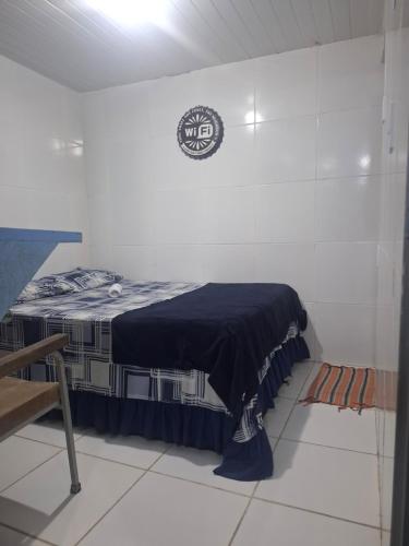 a room with a bed with a blue blanket on it at Hostel & Pousada UFPE INN in Recife