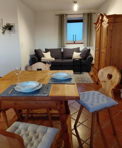 a living room with a table and a couch at Wohnung im ländlichen Flair in Bad Zell