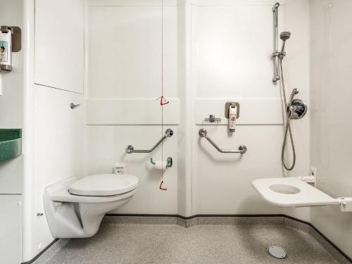 a small bathroom with a toilet and a sink at ibis Hull City Centre in Hull