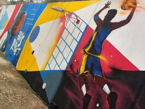 a mural of a basketball player on a wall at ibis budget Alicante Pension sin comedor in Alicante