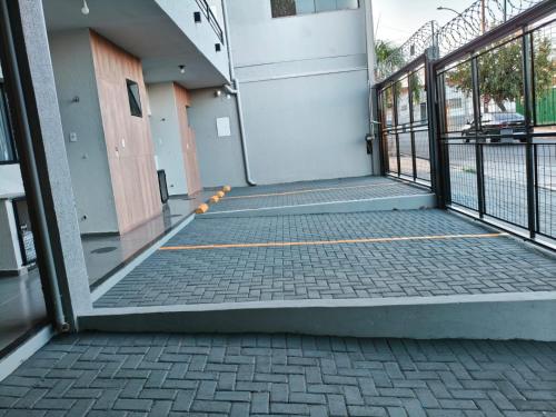 an open door of a building with a sidewalk at Xavi Studio in Bauru