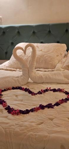 un cigno fatto di asciugamani su un letto di Casa Jardim Mar a Anchieta
