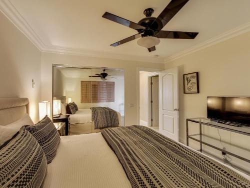 a bedroom with a bed and a ceiling fan at Solana Oceanfront with Pool, Spa, Ocean Views in Solana Beach