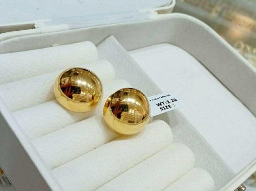 two gold balls in a box with a price tag at Amani Grand Resort Residences near Mactan Cebu Intl Airport in Mactan